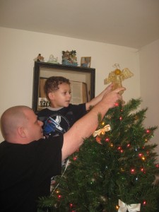 Daddy and Jace putting the Angel on the top of the tree